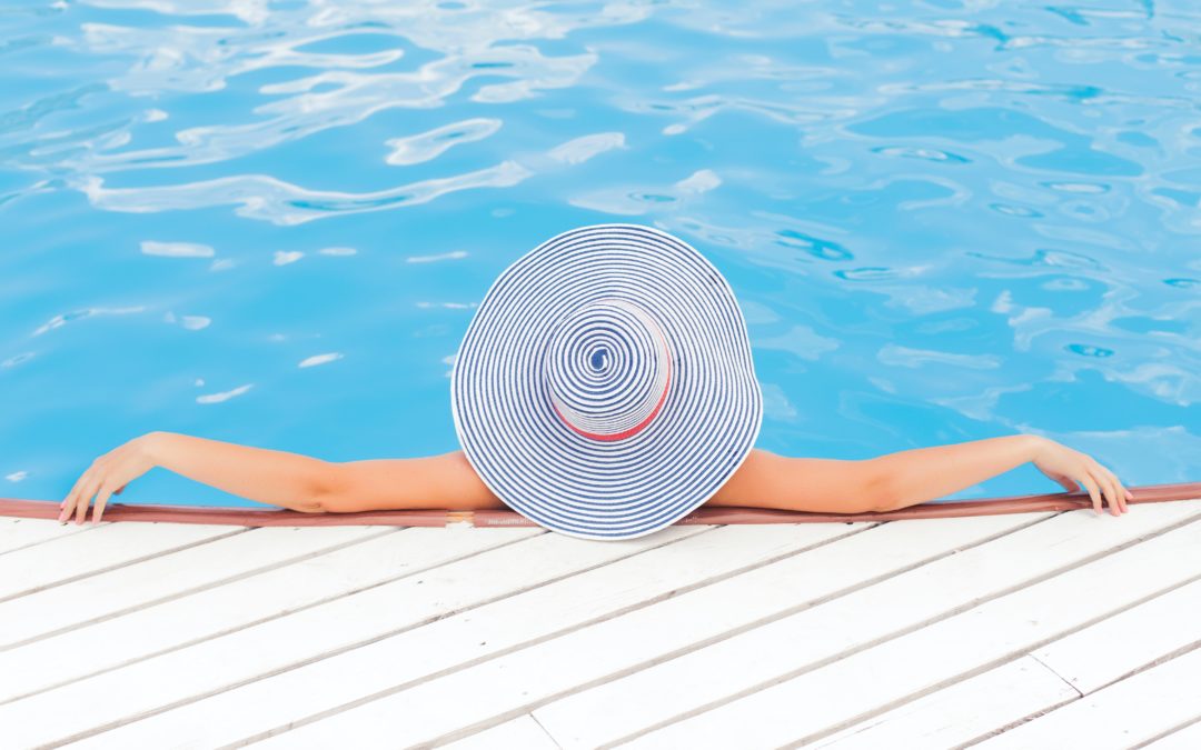 image of a person relaxing poolside against a deck